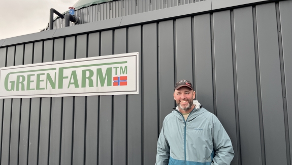 GreenFarmer Christian Hansen standing in front of his GreenFarm plant